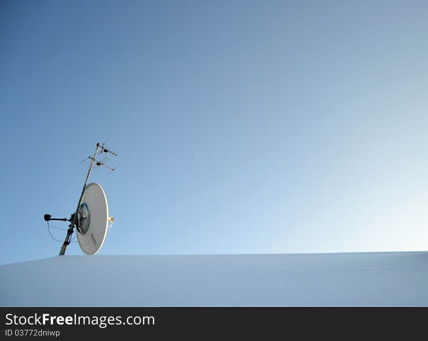 Satellite on roof covered with snow