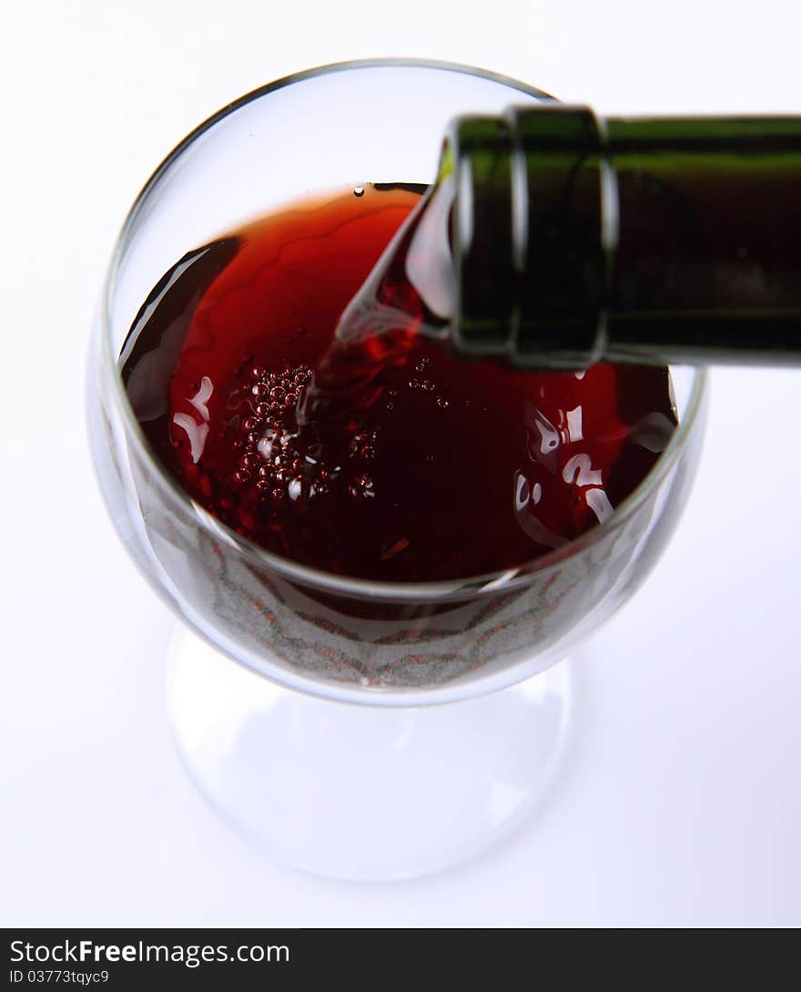 Red wine being poured into a wine glass