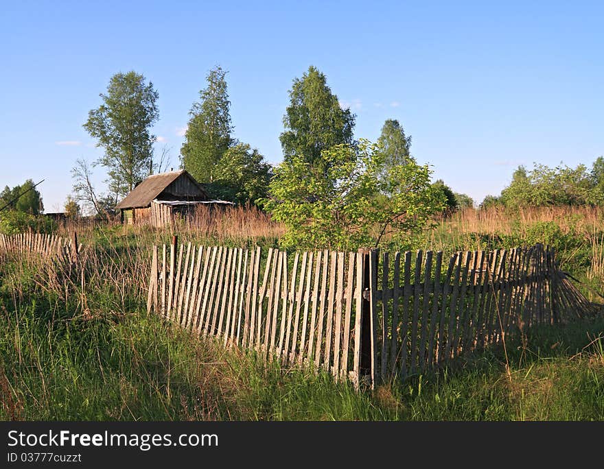 Old wooden fence near farmhouse