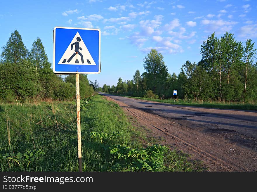 Road sign near asphalt road