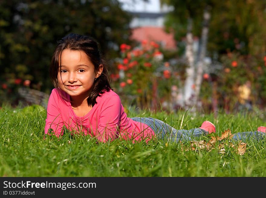 Little Girl Laying On Grass