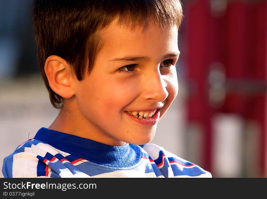 Portrait of smiling little boy - golden light