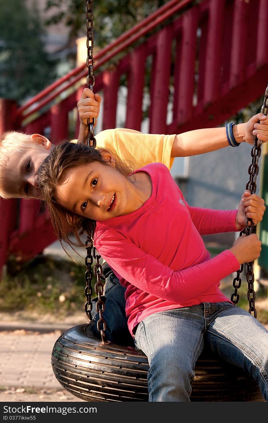 Boy and girl on swing