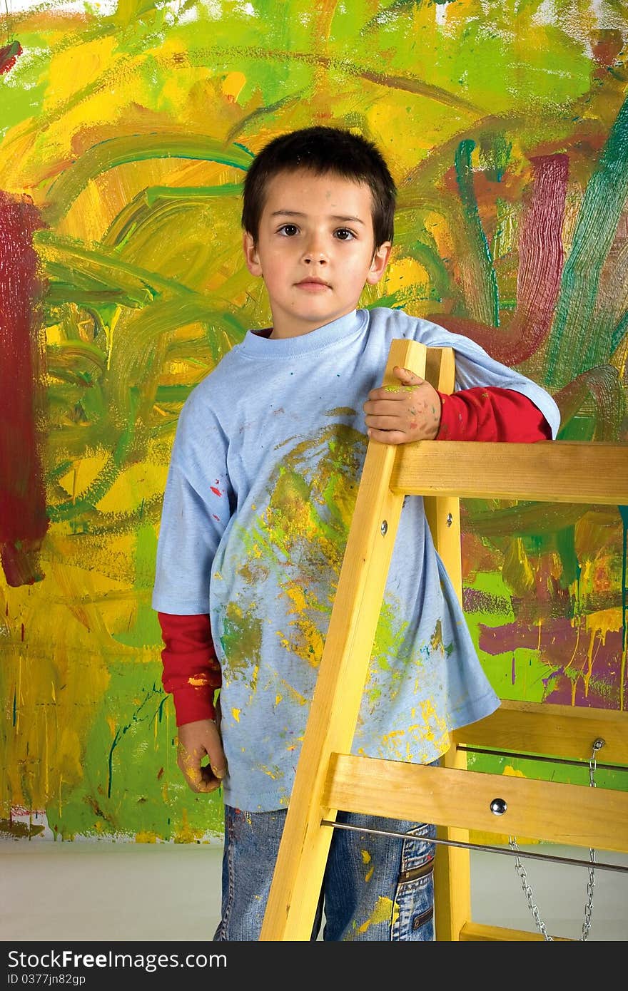 Little boy on ladder in front painted wall