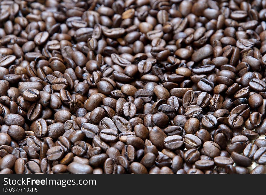 Background of small  black roasted coffee beans. Background of small  black roasted coffee beans