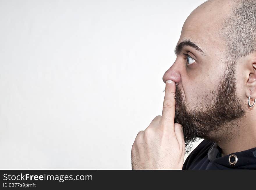 Man with his finger in the nose on white background