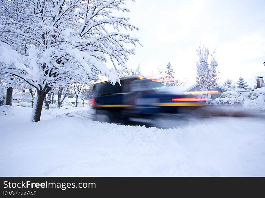 The lights and blur of a snowplow the morning after a heavy snowstorm. The lights and blur of a snowplow the morning after a heavy snowstorm