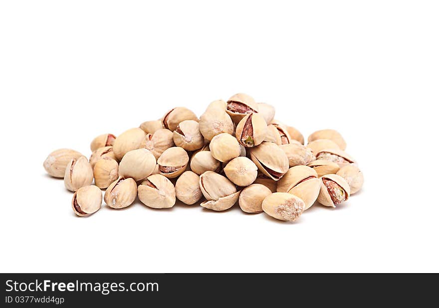 Heap of pistachios nuts on a white background. Heap of pistachios nuts on a white background.