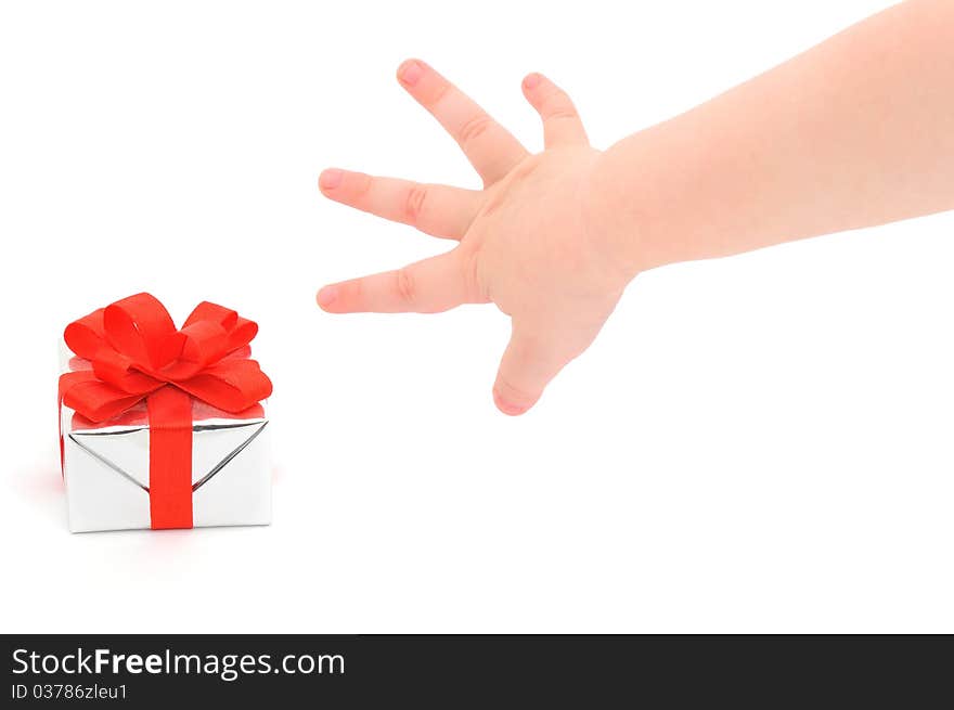 A child's hand taking a gift.  Isolated on white.