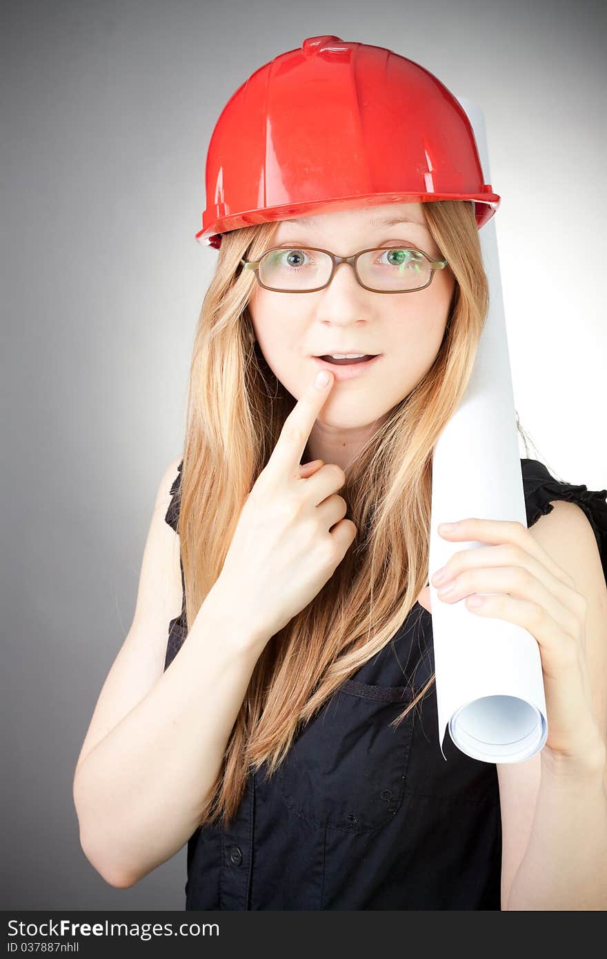 Young Engineer Woman In Helmet With Blueprint