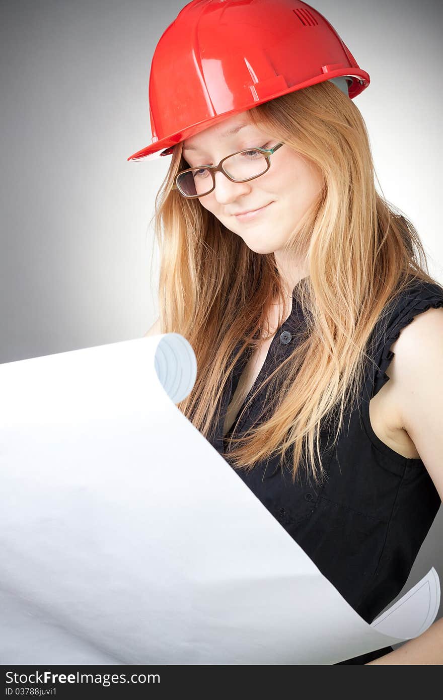 Young Engineer Woman In Helmet With Blueprint