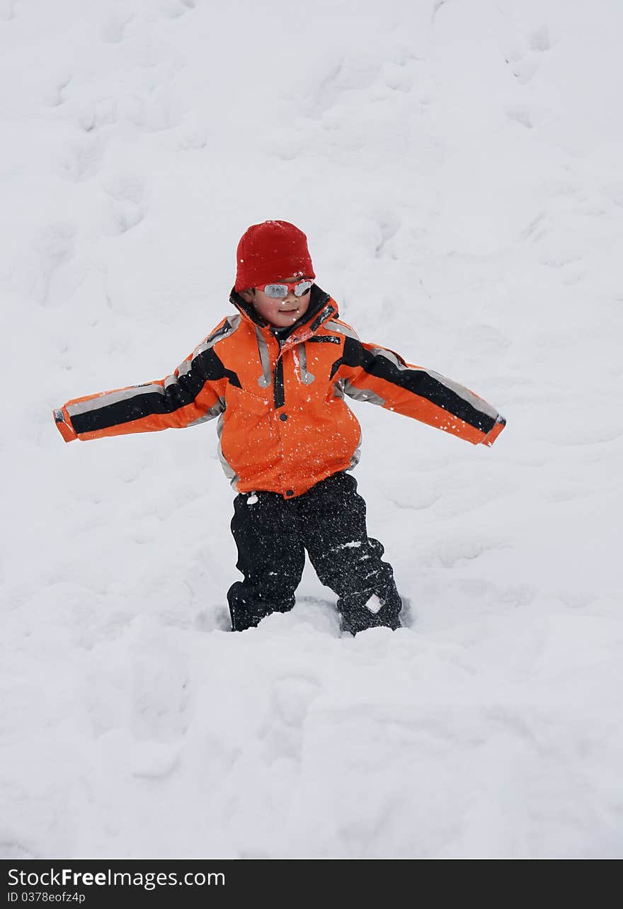 Picture of a little chinese boy lying in heavy snow and having great fun. Picture of a little chinese boy lying in heavy snow and having great fun