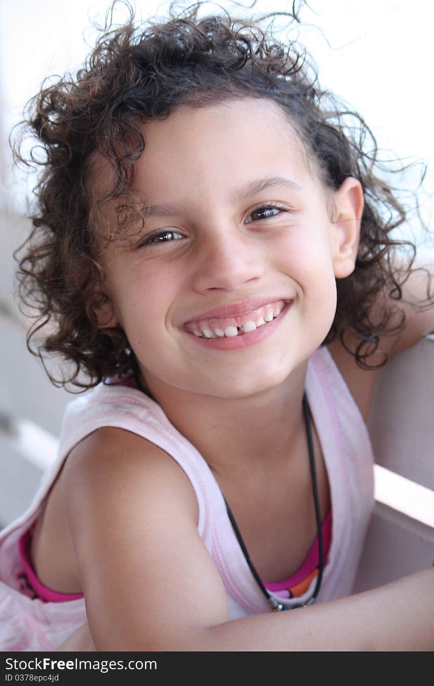 A smiling happy little girl outdoors. A smiling happy little girl outdoors