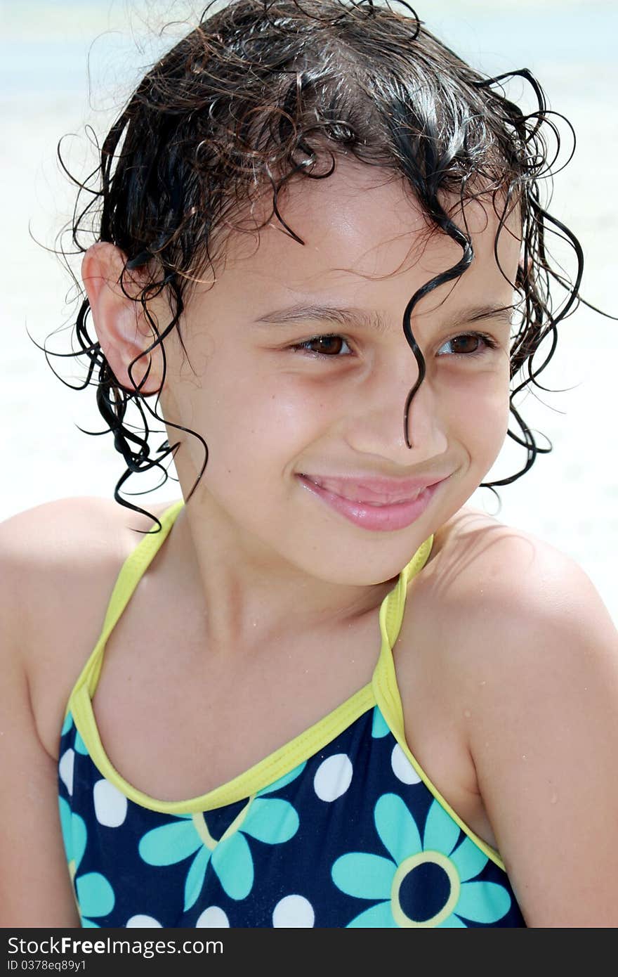 A little girl smiling at the beach. A little girl smiling at the beach.