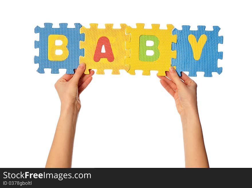 Teacher holding in the hand the amusing colored educational puzzles with the word baby