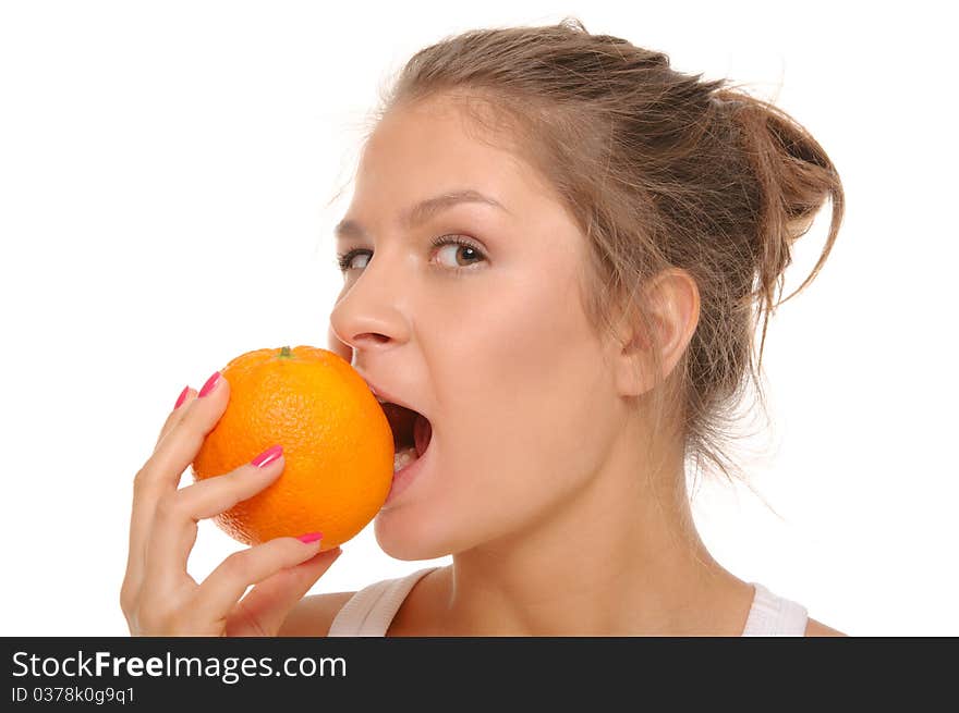 Young woman bites an orange