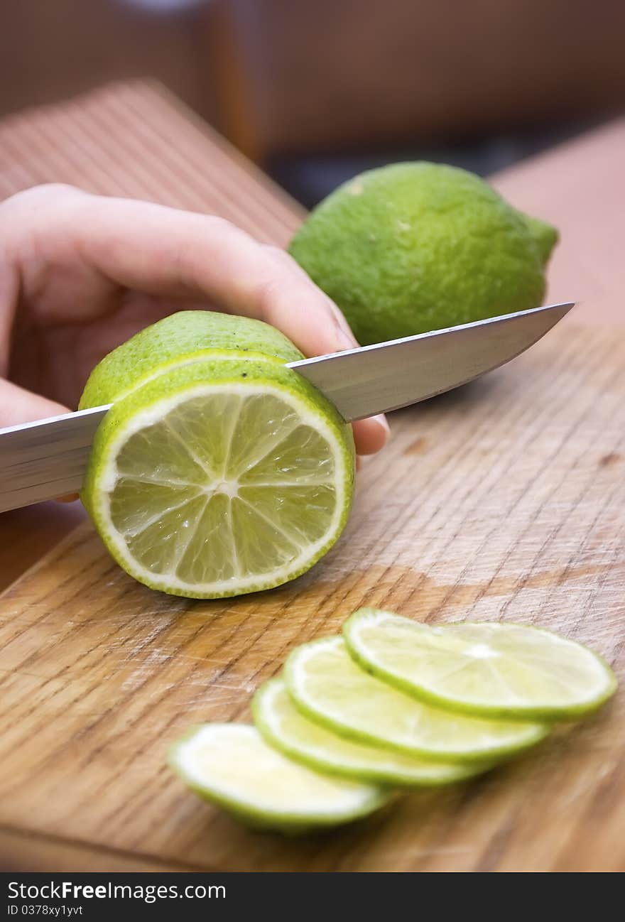 Lemon wait to be cut on a worn butcher block cutting board. Lemon wait to be cut on a worn butcher block cutting board