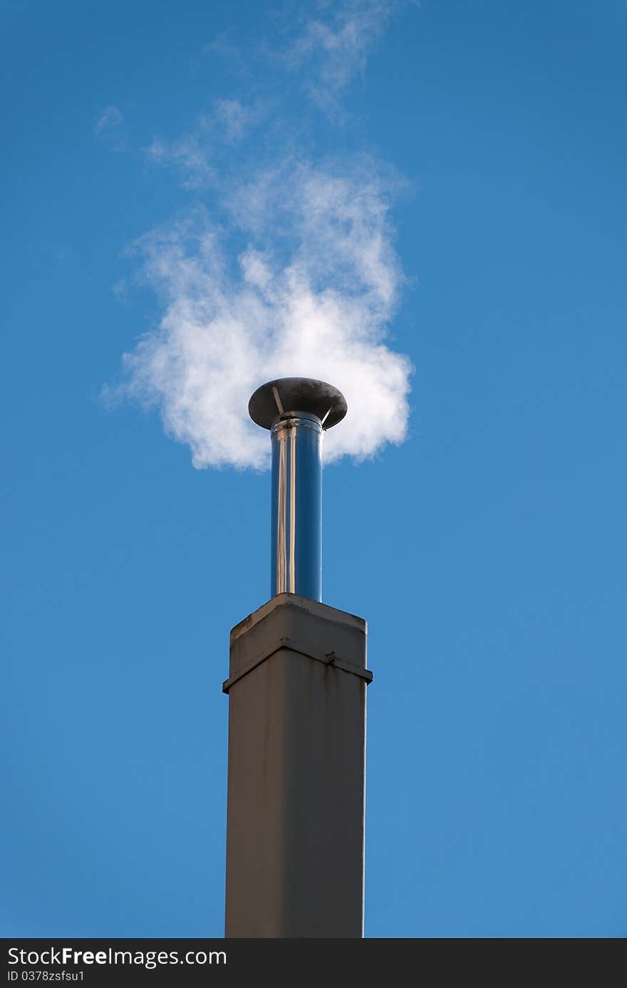 Chimney with smoke out the sunlit. Chimney with smoke out the sunlit