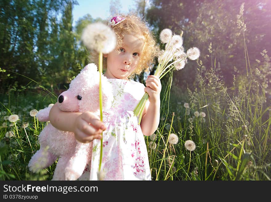 Little blond girl with dandelions. Little blond girl with dandelions.