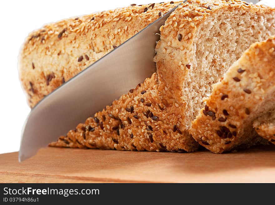 Fresh bread and knife isolated over white