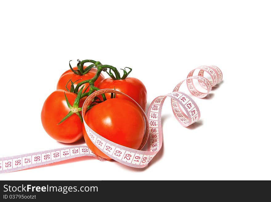 Tomato and tape measure isolated over white. Tomato and tape measure isolated over white