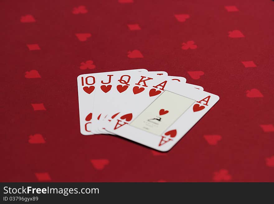 Flush of hearts - Set of 4 official playing poker cards on the casino table