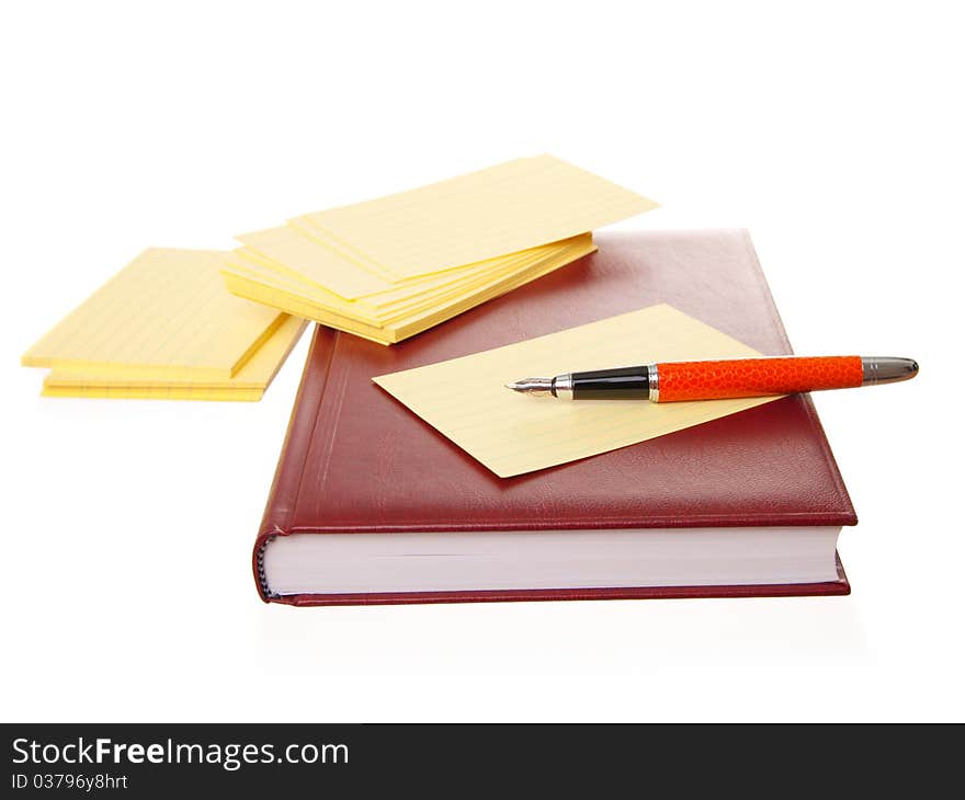 Notebook and pen, isolated on white background