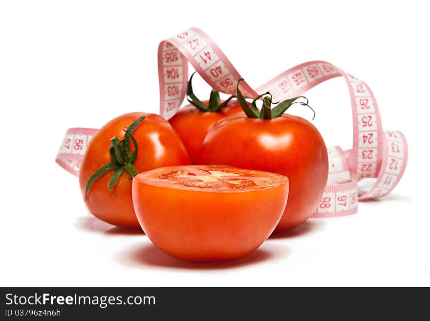 Tomato and tape measure isolated over white