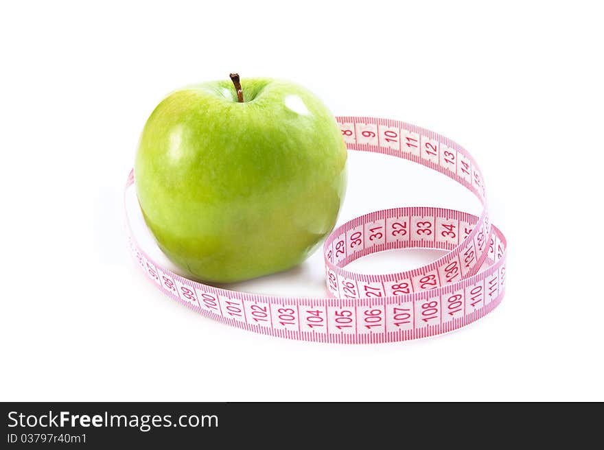 Green apple and tape measure isolated over white