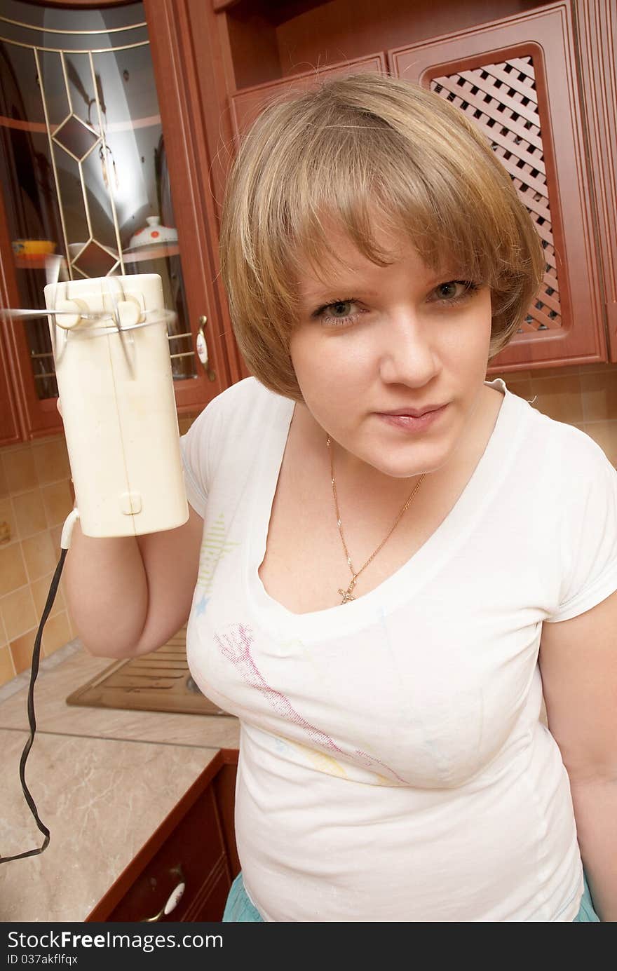 A pretty girl preparing pancakes