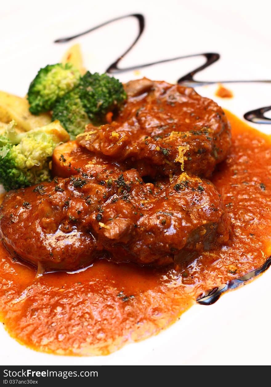 Veal shank served with special gravy and side dishes