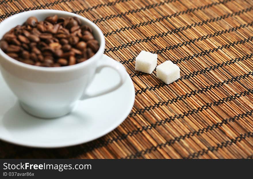 Stock Photo: cup of coffee beans and sugar cubes