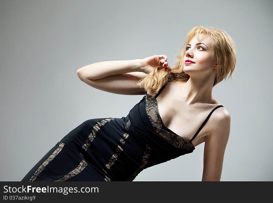 Young beautiful high blonde in a black dress