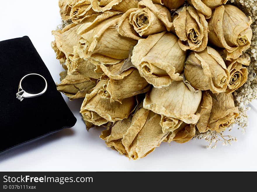 Dried roses bouquet and engagement ring