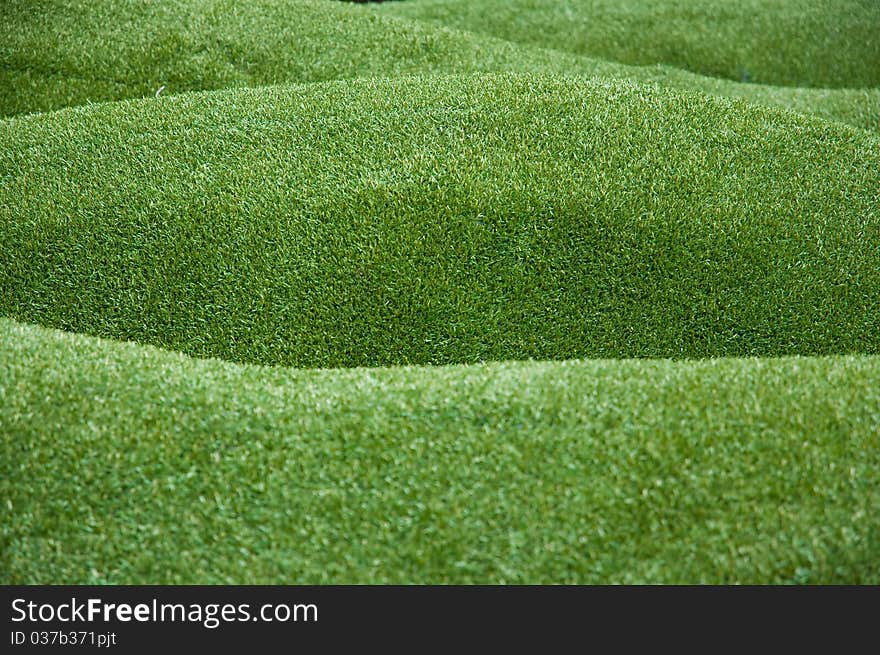 Green artificial grass background close up