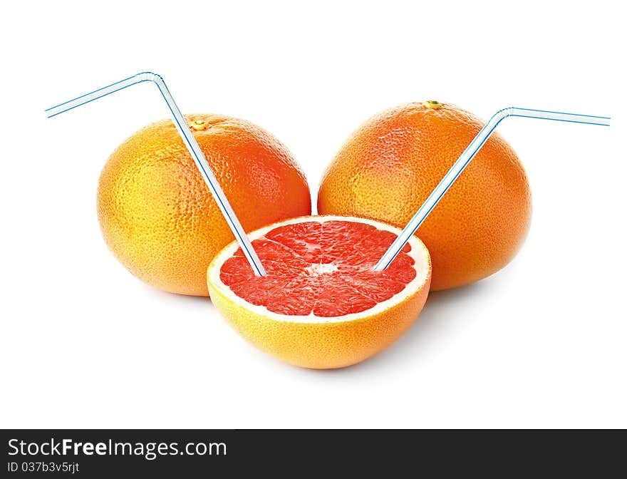 Three juicy grapefruits and cocktail tubes on a white background