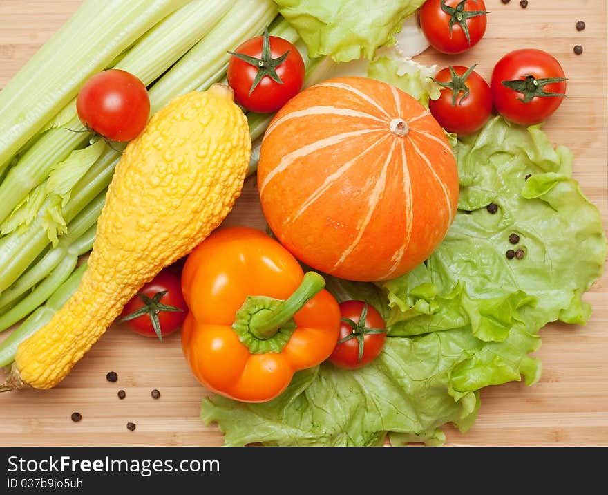 Large bright assortment of fresh vegetables on a cutting board