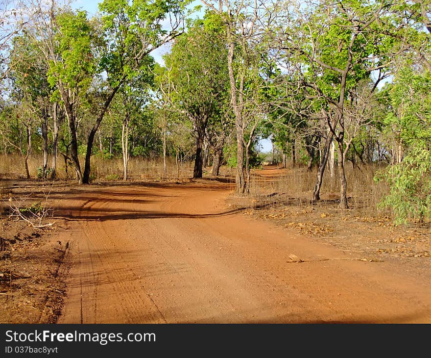 Gravelled road in the outback of Australia through the australian bush. Gravelled road in the outback of Australia through the australian bush