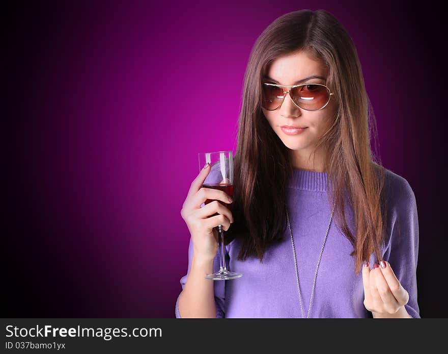 Women on red is holding a glass of white wine. Women on red is holding a glass of white wine