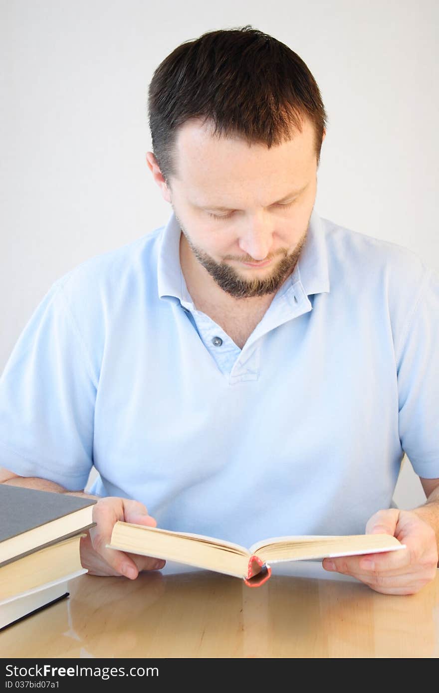 Man enjoying reading his book. Man enjoying reading his book