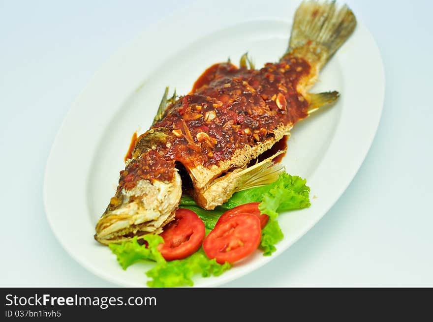 Fried snapper with chili sauce on the plate