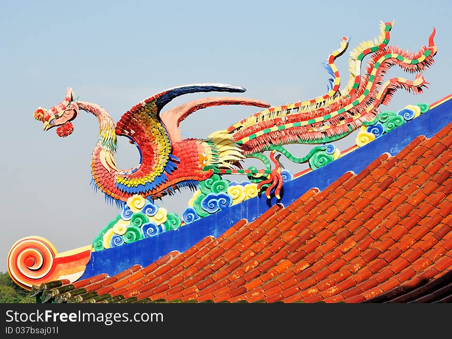 A legend Chinese sea bird sculpture on the roof with blue sky