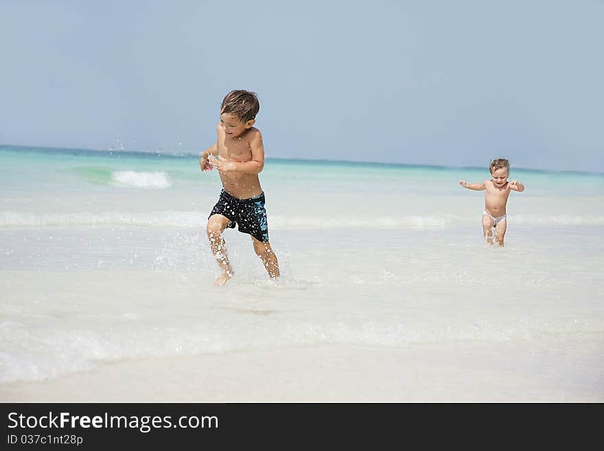 Two children running on beach. Two children running on beach