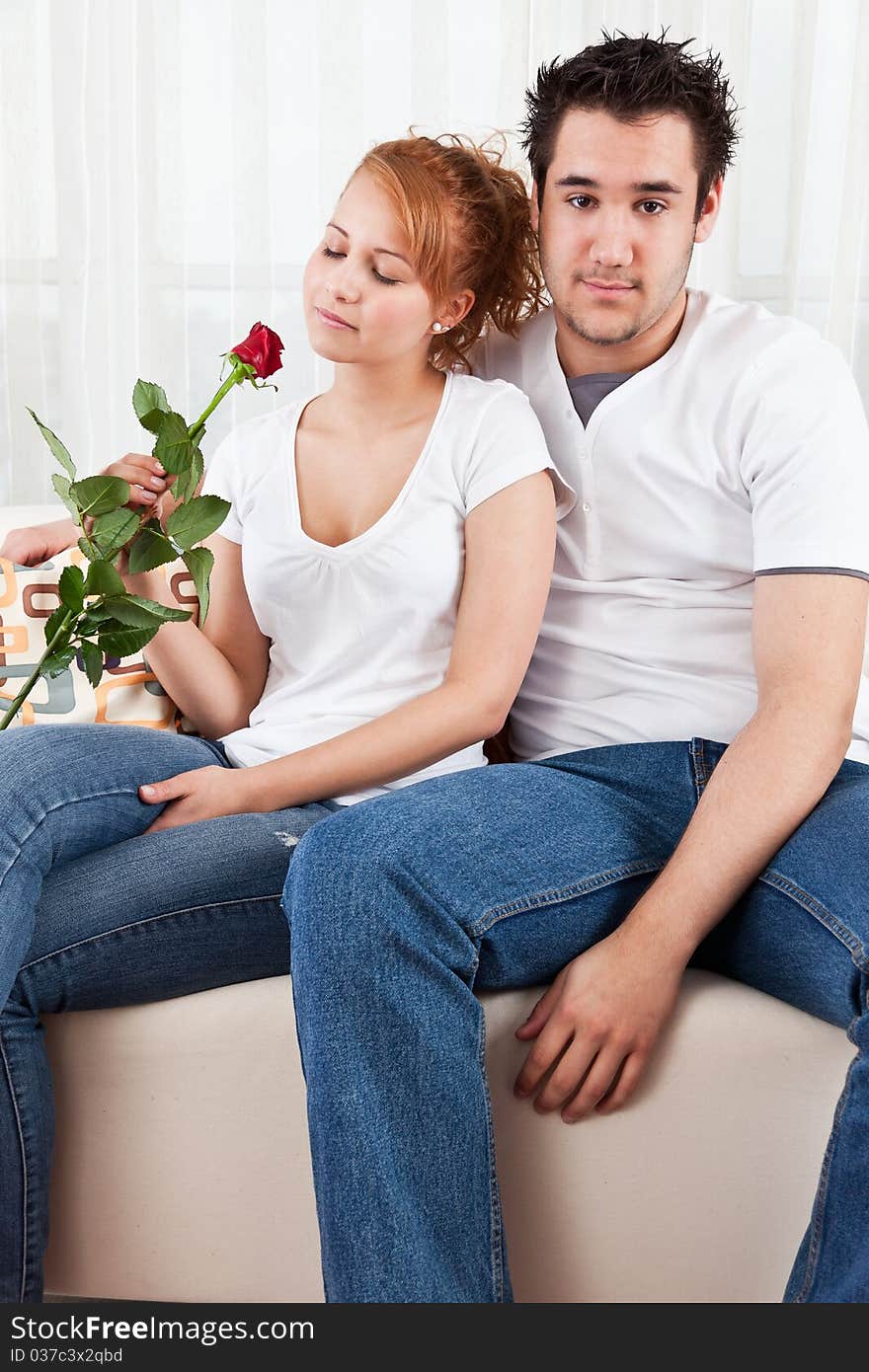 Young boy and a beauty, young girl with red rose