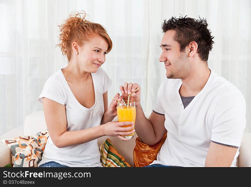 Young Boy And A Beauty Girl Drinking Ora