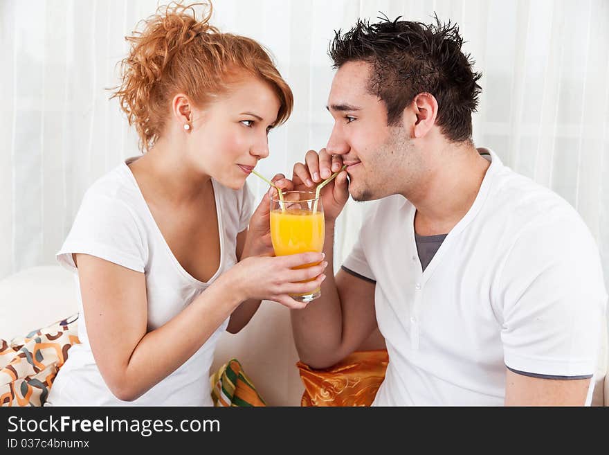 Young Boy And A Beauty Girl Drinking Ora