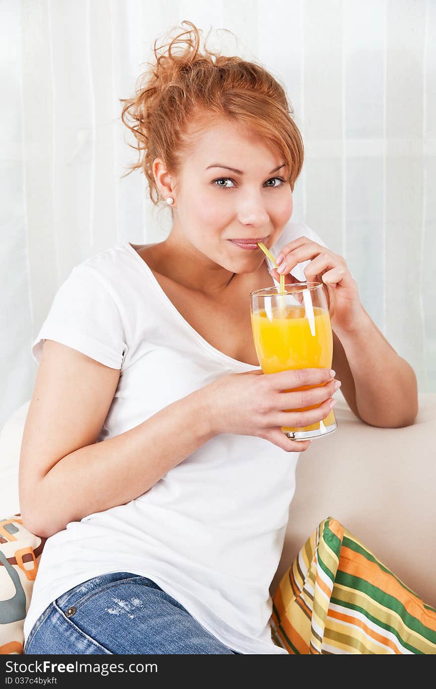 Beauty, young girl drinking a glass of orange juice