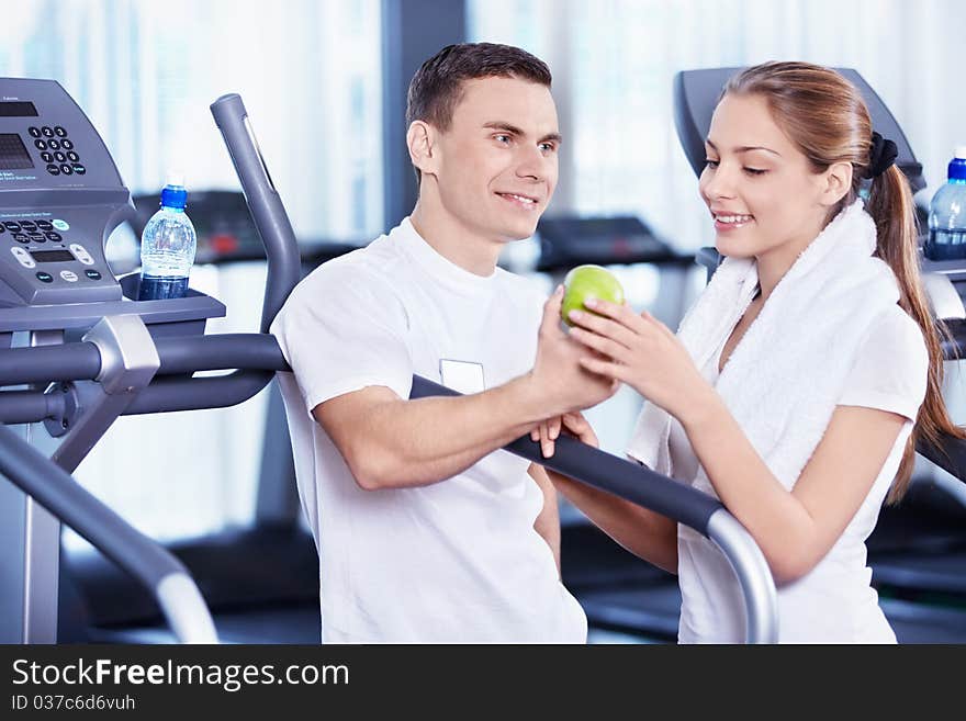 Coach gives young woman a green apple. Coach gives young woman a green apple