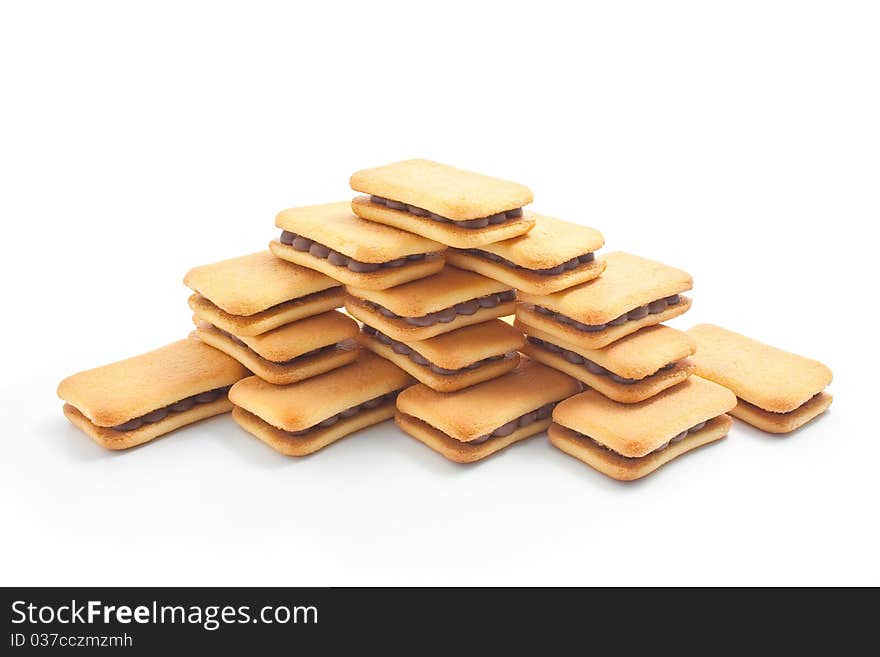 Sandwich biscuits with chocolate filling arranged in the shape of a pyramid isolated on white background. Sandwich biscuits with chocolate filling arranged in the shape of a pyramid isolated on white background