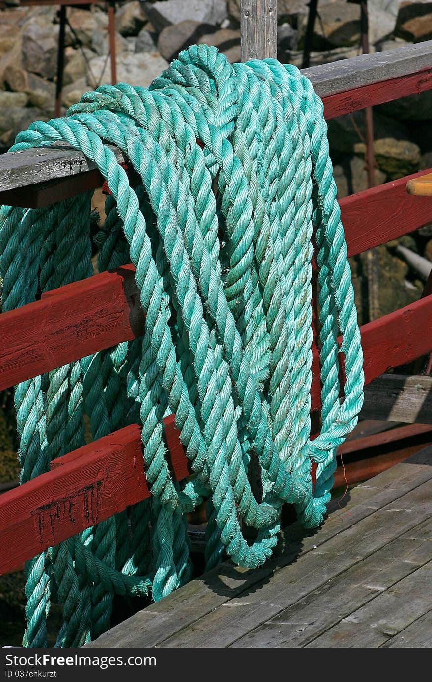 Green ship rope hanging on a fence. Green ship rope hanging on a fence